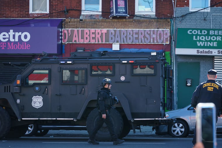 Police at the scene where a SWAT officer was shot, on the 100 block of West Lehigh Avenue on Friday.