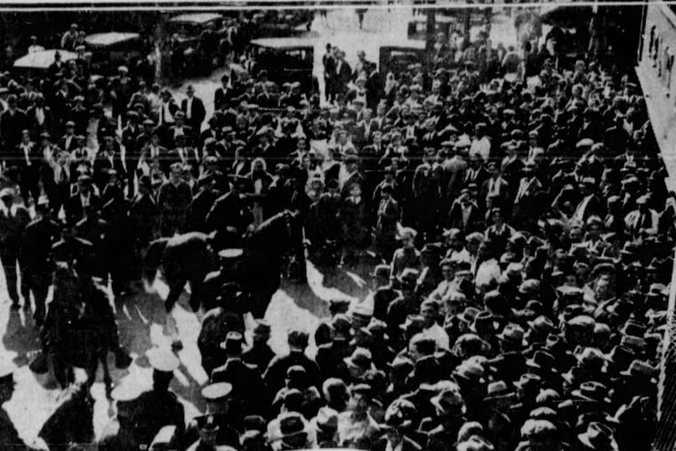 A photo of parishioners laying protesting outside Our Lady of Good Counsel on May 3, 1933. It would officially merge with St. Paul’s Church at midnight.