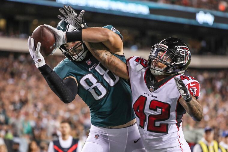 Eagles tight end Dallas Goedert, left, could not hold onto the pass in the end zone as Falcons LB Duke Riley broke it up in September 2018.
