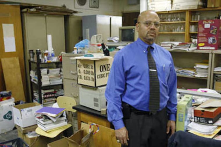 Principal Anthony Irvin in a crowded chemistry storage room at University City High School. (Michael S. Wirtz / Staff Photographer)