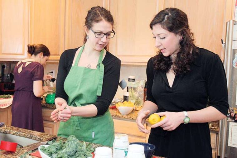 Shelby Zitelman, 28 (left), and her younger sister, Amy Zitelman, 24, are making Kale Salad & Quinoa.