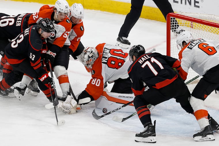 Carolina Hurricanes left wing Taylor Hall (right center) find the puck to score the game-winning goal against Philadelphia Flyers goaltender Dan Vladar in overtime in Game 2 of the Eastern Conference second round Stanley Cup playoffs on Monday, May 4, 2026 in Raleigh, North Carolina.