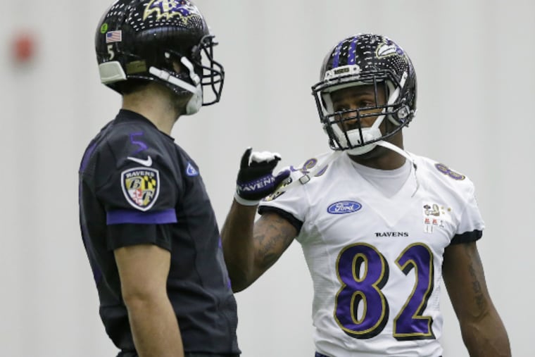 Ravens wide receiver Torrey Smith (right) talks with quarterback Joe Flacco during practice as they prepare for their game against the Steelers. (AP)