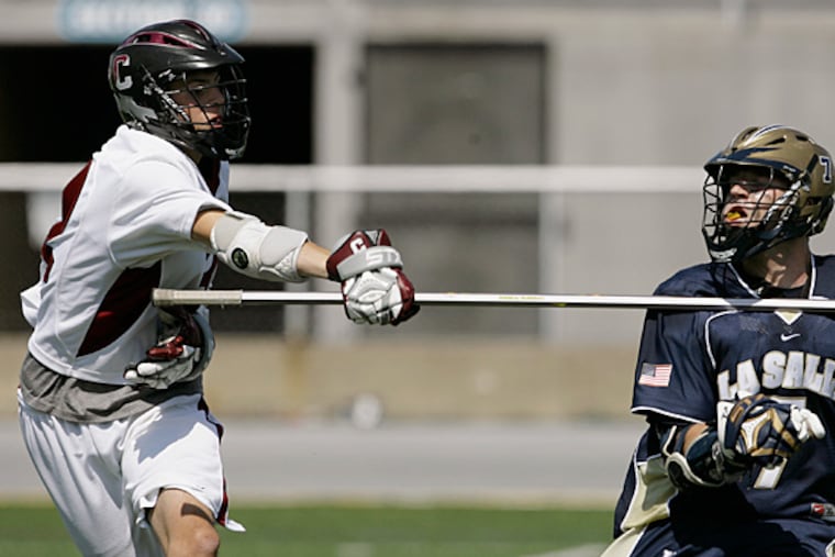 Conestoga's Casey Ikeda (L) checks La Salle's Randall Forster during
the PIAA boys state lacross championship game in Hershey, Pa. June 6,
2009. (Christopher Gardner/ For the Inquirer)