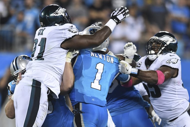 Eagles defensive tackle Fletcher Cox (left) and Brandon Graham (right) sack Panthers quarterback Cam Newton.