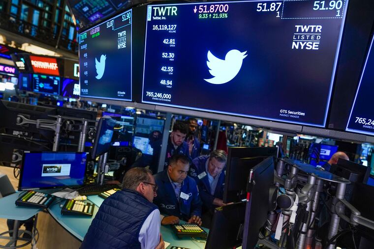Traders gather around a post as Twitter shares resume trading on the floor at the New York Stock Exchange in New York, on Oct. 4, 2022.