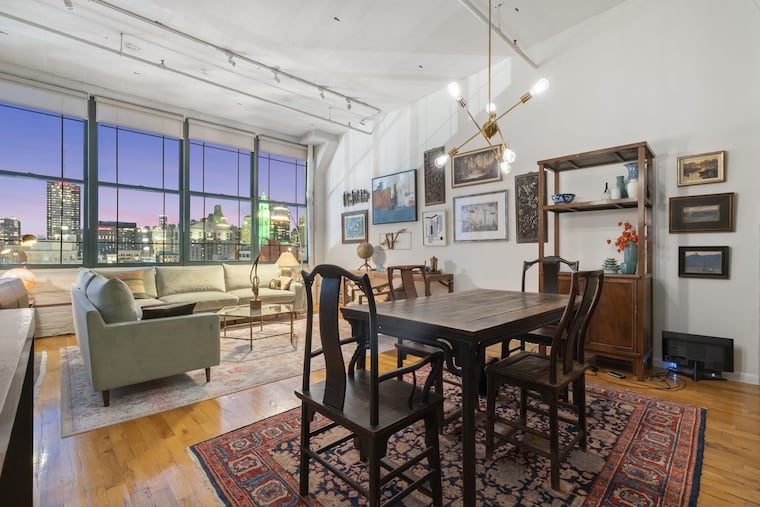 The dining area and living room, with city skyline views.