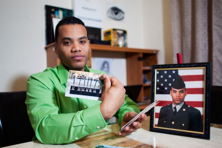 Neuris Felix sits at his dining room table, with his official Army portrait as well as snapshots from Iraq, in the apartment he shares with wife Carolina in Lancaster. (Ed Hille / Staff Photographer)