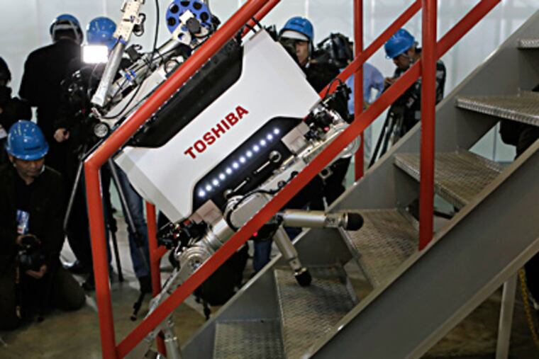 Toshiba Corp.'s inspection robot climbs stairs during a factory demonstration near Tokyo. It is designed to venture into off-limits areas of the crippled Fukushima Dai-ichi nuclear plant. ITSUO INOUYE / Associated Press