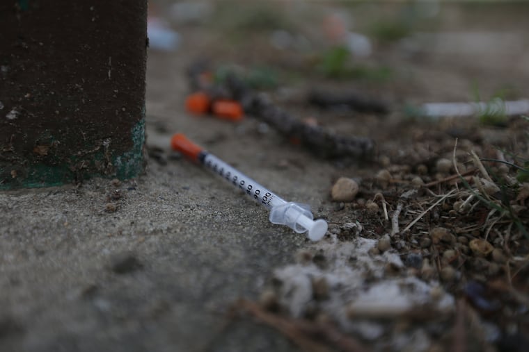 A needle sits next to a bench on the lawn around McPherson Square Library in Philadelphia, PA on July 24, 2018. DAVID MAIALETTI / Staff Photographer