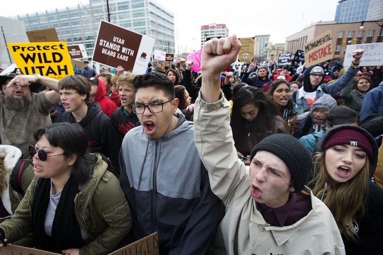 Protesters yell at police officers as they are stopped from marching up State Street during President Donald Trump’s announcement to eliminate vast portions of Utah’s Bears Ears and Grand Staircase-Escalante national monuments in Salt Lake City, Utah, earlier this month. Larger protests are planned if Trump fires special counsel Robert Mueller, as many are predicting.