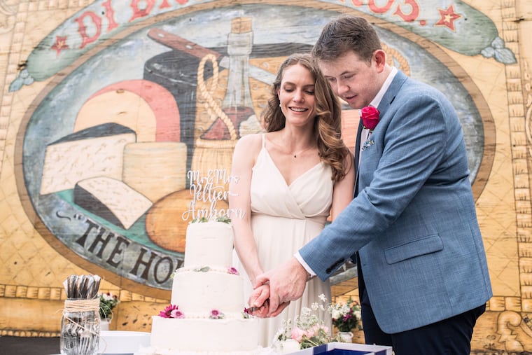 Bree and Ian Peltier-Amborn cutting the cake Ian's cousin made for them.