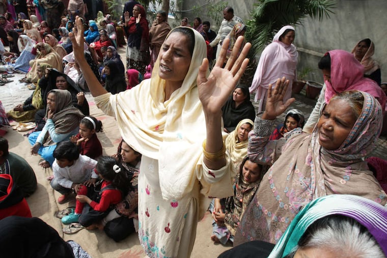 Christians in Lahore, Pakistan , pray for victims of a pair of suicide bombings at two churches Sunday. The Pakistani Taliban claimed responsibility. K.M. CHAUDARY / AP