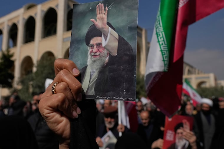 A woman holds up a picture of the late Iranian Supreme Leader Ayatollah Ali Khamenei as government supporters march against the ongoing U.S.-Israeli military campaign after Friday prayers at the Imam Khomeini Grand mosque in Tehran, Iran, Friday, March 6, 2026.