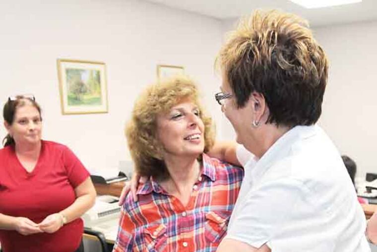 Charlene Kurland, 69, center, gives her partner, Ellen Toplin, 60, right, a big hug after they received their official Marriage License from Second Deputy, Helene Sepulveda, left, in Norristown, PA. Recorder of Wills Office, 4th floor, One Montgomery Plaza, Norristown. Two women have been married in a religious ceremony near Philadelphia after getting a same-sex license from county officials defying a state ban. They simply want to take advantage of the opportunity offered by Montgomery 07/24/2013 ( MICHAEL BRYANT / Staff Photographer )