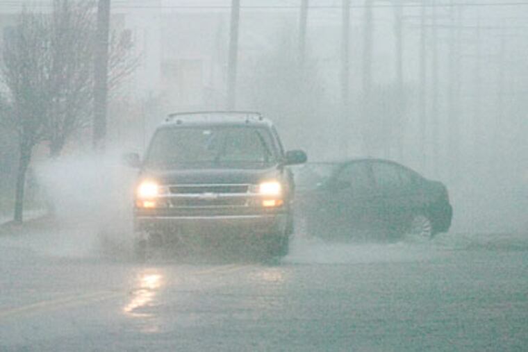 A truck drives down a flooded Landis Avenue in Sea Isle City. (Ron Tarver / Staff Photographer)