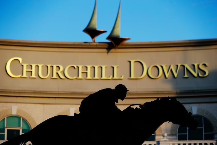 A statue of Barbaro is silhouetted at the entrance of Churchill Downs in Louisville, Ky., home of the Kentucky Derby.