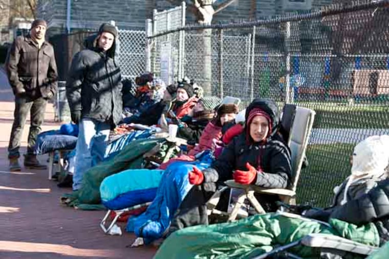 Parents brave the cold as they wait in line for kindergarten registration next Tuesday at Penn Alexander in West Philadelphia. ( RON TARVER / Staff Photographer )