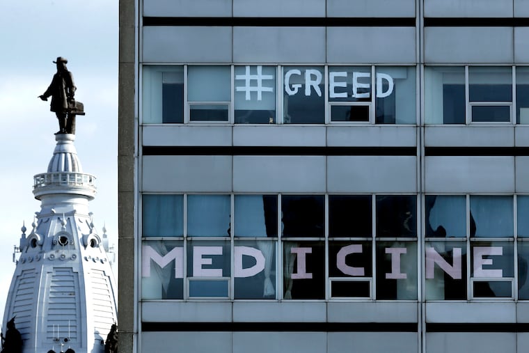 Messages in some of the windows at Hahnemann University Hospital on July 25 after medical residents and staff of the hospital were informed that their residencies would end soon.