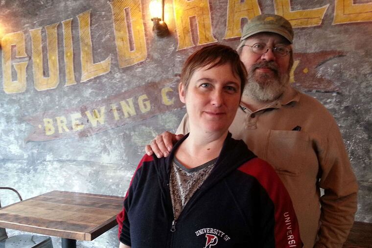 Owen Hutchins with Jennifer McGuire, owners of Guild Hall Brewing Co.