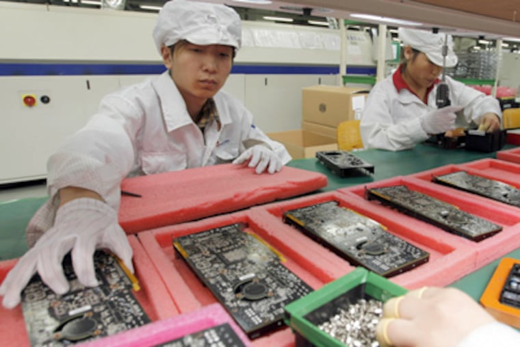 At the Foxxconn complex in Shenzhen, China, workers assemble electronic products. Among the items put together at the numerous factories there are iPods, iPhones, and iPads. (Kin Cheung / Associated Press, File)