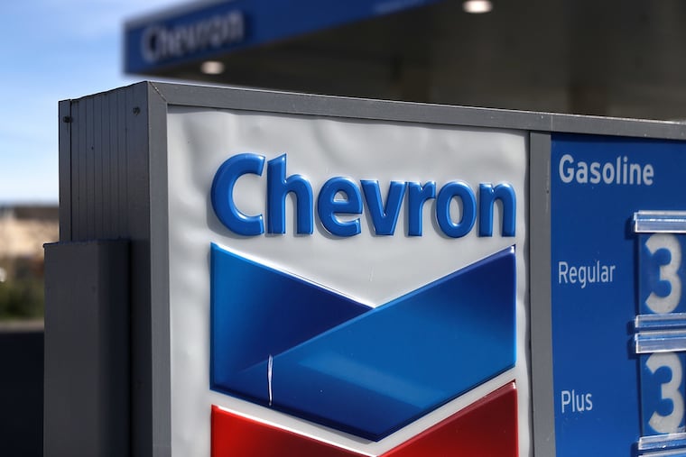 A sign is posted in front of a Chevron gas station on Feb. 2, 2018, in Corte Madera, California. The Biden administration has granted Chevron a license to resume oil production in Venezuela.