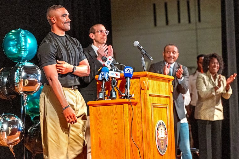Eagles quarterback Jalen Hurts as he appears at a rally in the auditorium at Northeast High School Tuesday, Sept. 15, 2026 to give the school $600k for an air conditioning system. With him onstage in the auditorium Northeast principal Andrew Lukov, School Superintendent Tony B. Watlington, Sr. and Mayor Cherelle L. Parker.