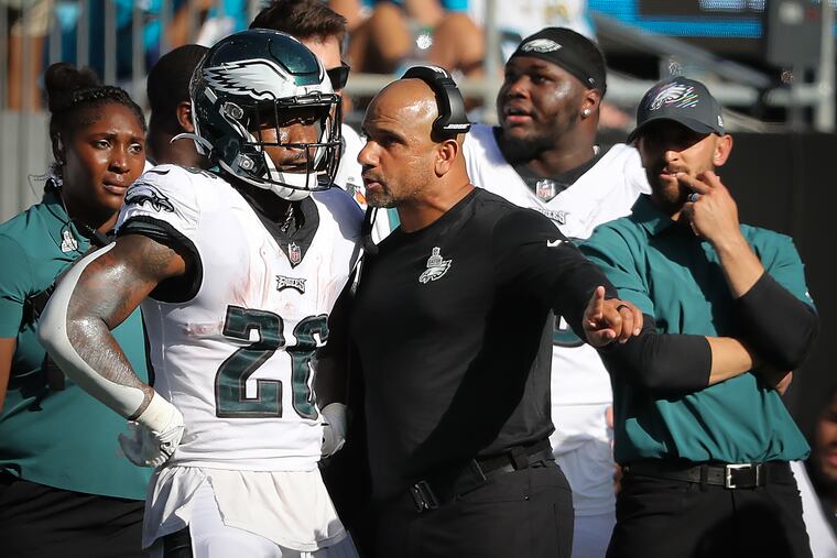 Jemal Singleton (right) talking with running back Miles Sanders on Oct. 10.