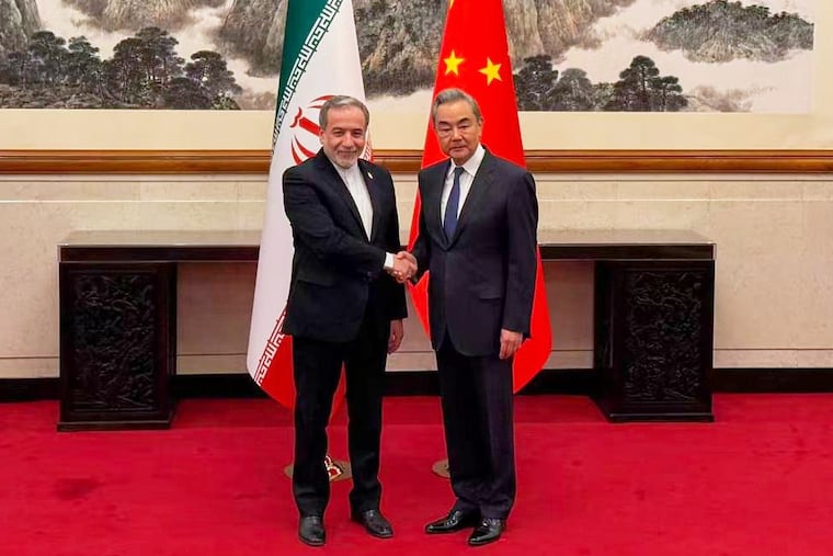 In this photo released by the Telegram channel of Iranian Foreign Minister Abbas Araghchi, China's Foreign Minister Wang Yi, right, meets with Iran's Foreign Minister Abbas Araghchi in Beijing, China, Wednesday, May 6, 2026.