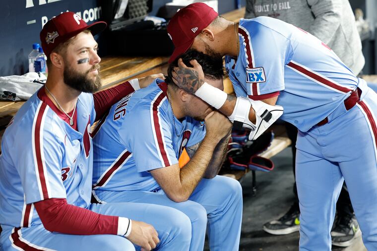 Phillies infielder Edmundo Sosa consoles pitcher Orion Kerkering after losing Game 4 of the National League Division Series against the Los Angeles Dodgers Thursday.