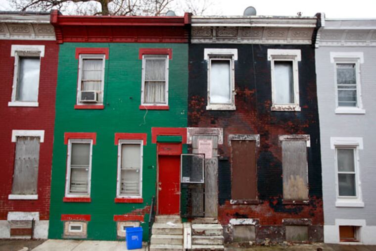 The boarded-up rowhouse on the right, 1224 W. Harold St., in North Philadelphia, is the registered address of investor Edward Williams, who has been dead for 15 years. DAVID SWANSON / Staff Photographer