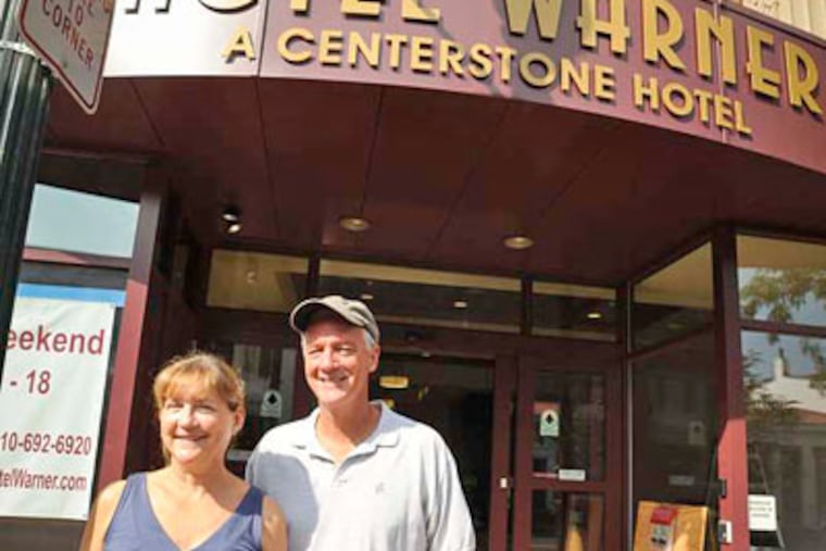 Ellen and Brian McFadden stand in front of the Hotel Warner, in a former movie theater. (RON TARVER / Staff Photographer)