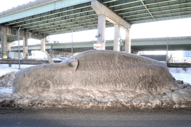 A car remains covered in ice at the corner of Allen St. and Front St. in Philadelphia on Friday, Jan. 26, 2026.