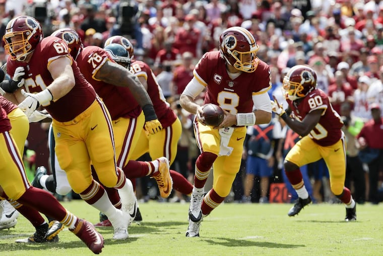 Redskins quarterback Kirk Cousins prepares to hand off l against the Eagles on Sept. 10.