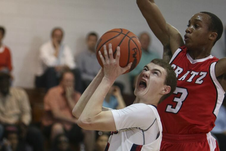 Plymouth Whitemarsh's Oakley Spencer makes a layup as Simon Gratz's Tariq Meredith defends.