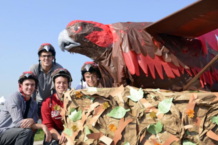 With their St. Joe's hawk are (from left) Mark McShane, Daniel Ezzo, Nicholas Shafer, and Kyle Smith. (TOM GRALISH / Staff Photographer)