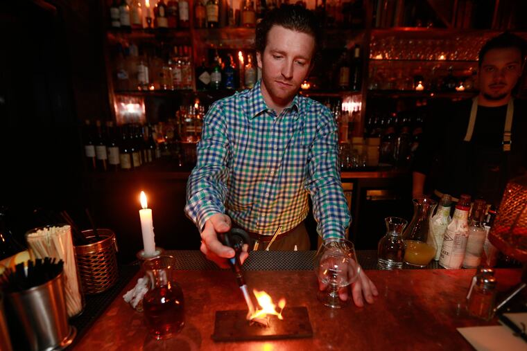 Zachary Davis makes the cocktail called the Double Knot at Double Knot, 120 S. 13th St.