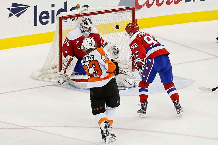 Philadelphia Flyers right wing Jakub Voracek (93) scores a goal on Washington Capitals goalie Braden Holtby (70) as Capitals center Evgeny Kuznetsov (92) defends in overtime at Verizon Center. The Flyers won 4-3 in overtime.