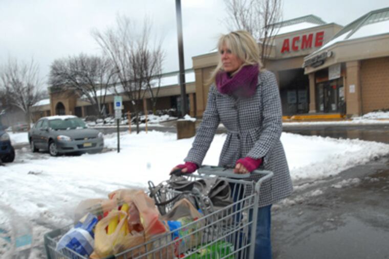 Karen Noworyta of Hainesport walks with a cart full of groceries outside of the Cinnaminson Acme in New Jersey. (April Saul / Staff Photographer)