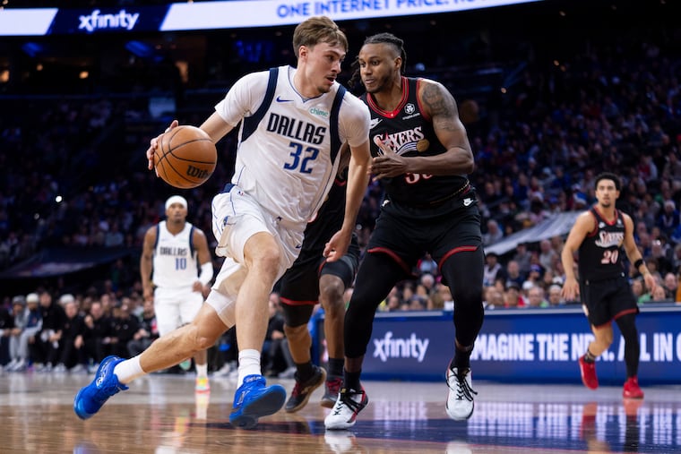 The Dallas Mavericks' Cooper Flagg drives to the basket against the 76ers' Jabari Walker.