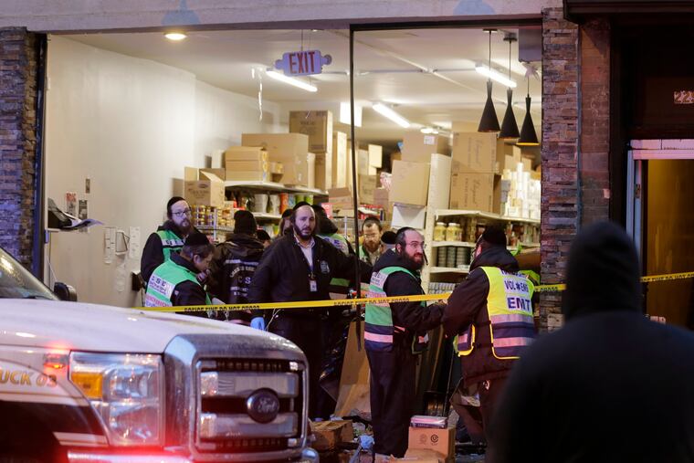 Emergency responders work at a kosher supermarket, the site of a shooting in Jersey City, N.J.