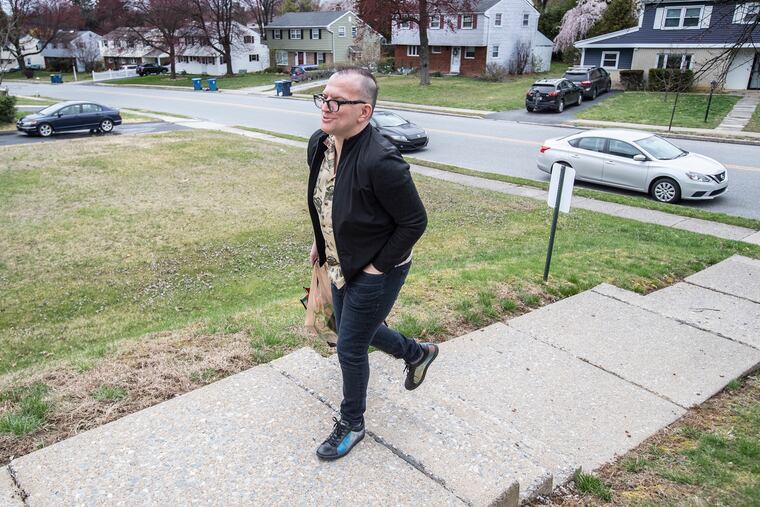 Bryan Buttler walks from his car up the steps of the Valley Forge Presbyterian Church in King of Prussia on March 25 to drop off food items for the Upper Merion Area Community Cupboard. Buttler is trying to do one small good thing every day as the coronavirus spreads its misery.