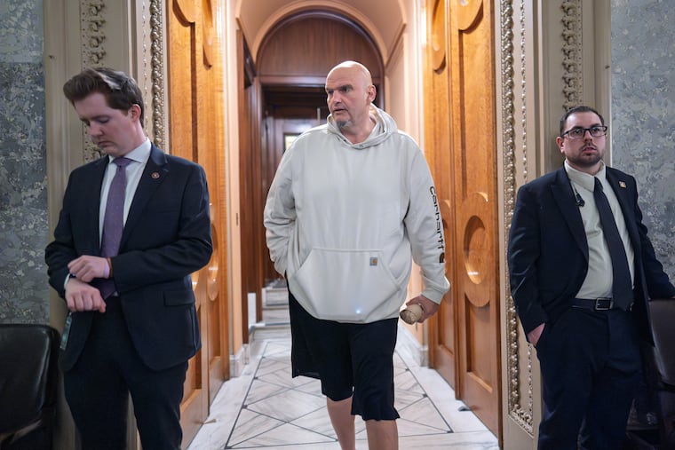 Sen. John Fetterman, D-Pa., walks through the U.S. Capitol Monday as the Senate works to bring the longest government shutdown in the nation's history to an end.