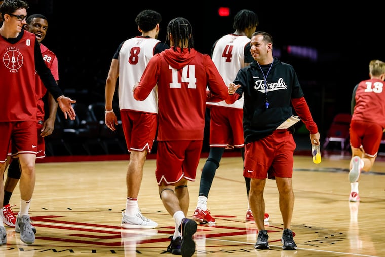 Head coach Adam Fisher interacts with his players during Temple's practice on Monday.