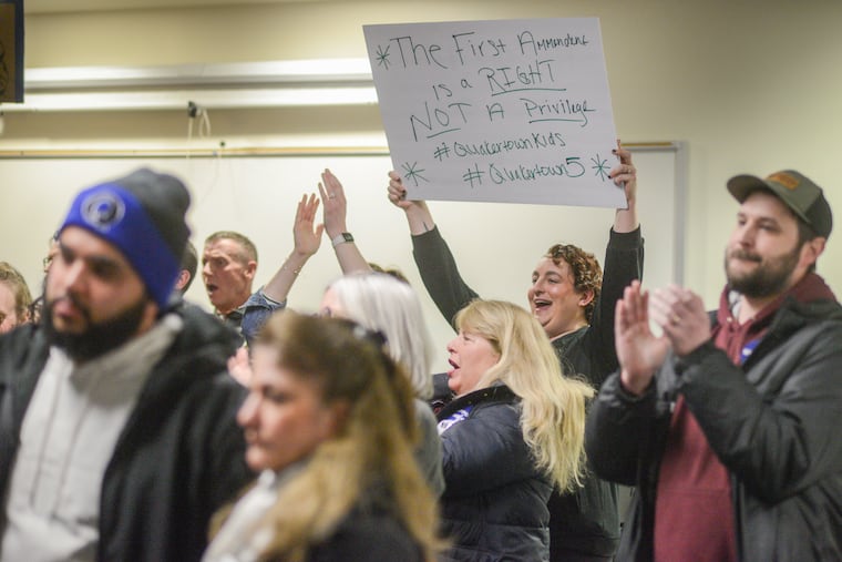 Parents and students react to a speaker at the Quakertown school board meeting Thursday. Community members said the district had mishandled the walkout that resulted in five teenagers arrested amid a clash with police.