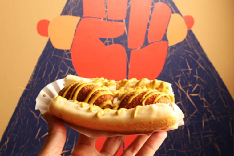 "The Back in the Day" from Underdogs features a hot dog with fish cakes and onions laced with mustard. ( Charles Fox / Staff Photographer )