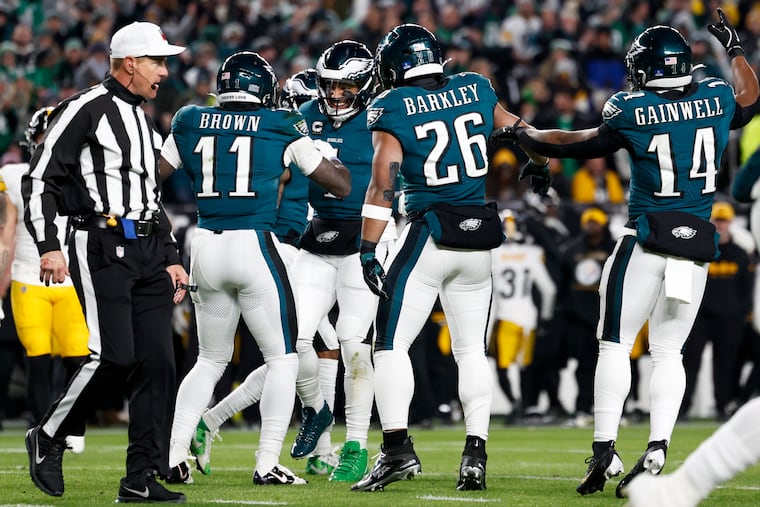 Eagles wide receiver A.J. Brown celebrates his touchdown with quarterback Jalen Hurts and other teammates during Sunday's win over the Steelers.