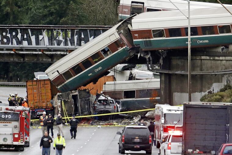 Cars from Amtrak Train 501 spill onto Interstate 5 in DuPont, Wash. Seventy-seven passengers and five crew members were aboard when the train derailed Monday.