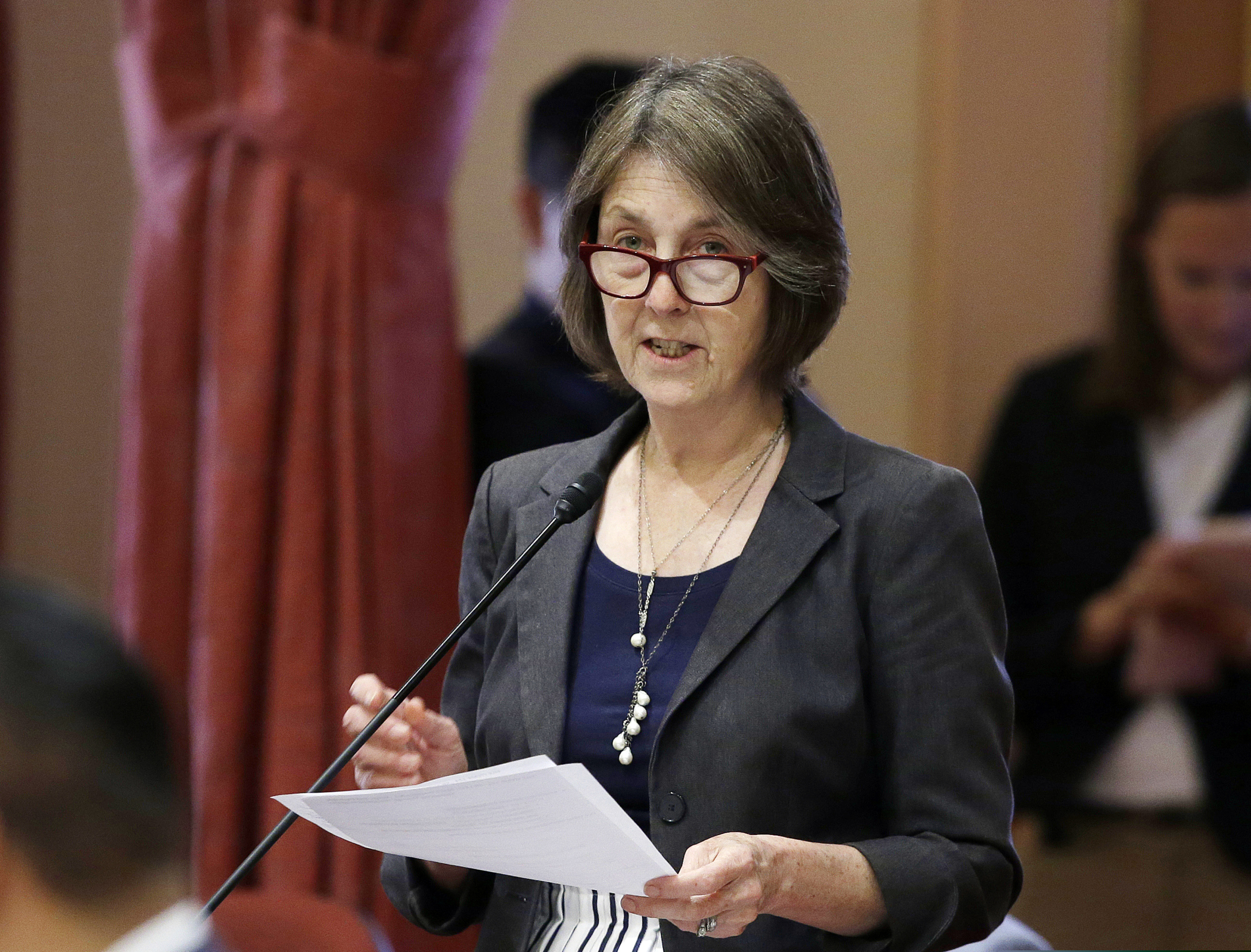 California state Sen. Nancy Skinner, D-Berkeley, speaks on the floor of the Senate in Sacramento, Calif., in 2018. The state Assembly approved Skinner's bill to let college athletes hire agents and be paid for the use of their name, images or likeness.