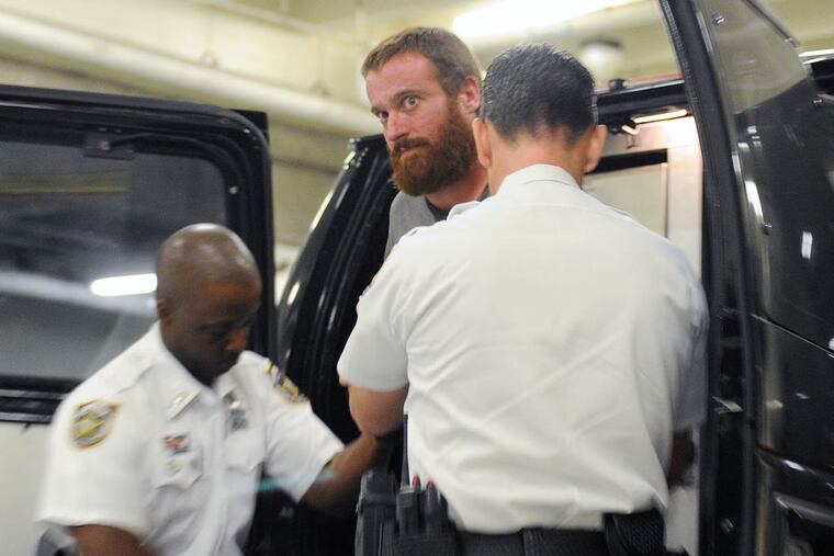 Joshua Hakken, center, is assisted by two Hillsborough County deputies after arriving at the Orient Road Jail, Wednesday, April 11, 2013 in Tampa, Fla. Joshua Hakken and his wife Sharyn Hakken, accused of kidnapping their two young sons and fleeing by boat to Cuba, were handed over to the United States and imprisoned and their children were returned to their maternal grandparents, who have official custody, authorities said Wednesday. The couple will face multiple charges including kidnapping. (AP Photo/Tampa Tribune, Chris Urso) OUTS: ST. Petersburg (Tampa Bay Times); Lakeland; Bradenton; Sarasota, Winter Haven; MAGS OUT; LOCAL TV OUT; WTSP CH 10 OUT; WFTS CH 28 OUT; WTVT CH 13 OUT; BAYNEWS 9; Online OUT.